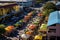 This captivating aerial perspective captures the bustling atmosphere of a street market in a quaint small town, An elevated view