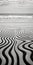 Captivating Black And White Wave And Sand Painting On The Beach