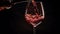 Captivating close up of dark red wine elegantly pouring into wine glass on enchanting backdrop