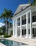 Captivating close up of elegant white villa against clear blue sky, showcasing architectural beauty