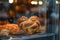 A captivating close-up photo capturing a display case filled with freshly baked artisanal bread loaves for sale, A heart-shaped