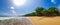 Captivating deserted beachscape with a radiant sun in a clear sky in Ghana, Africa