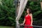 Captivating Elegance: Woman in Red Dress Posing in Restaurant Garden