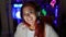 Captivating live stream, radiant young redhead streamer woman, smiling, embracing high-tech gaming in cozy room, headphones on