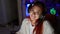 Captivating live stream, radiant young redhead streamer woman, smiling, embracing high-tech gaming in cozy room, headphones on