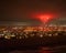 Captivating night scene with a vibrant display of red fireworks illuminating the sky over Oxnard