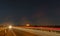 Captivating Nighttime Highway Drive: Starlit Sky and Light Trails