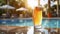 captivating photo of a transparent glass of light cold beer, reflecting sun brilliance near inviting pool. Ai generated