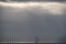 Captivating shot of a seascape featuring distant storm clouds and towering wind turbines