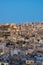 Captivating skyline of Amman, Jordan traditional houses atop a picturesque hill during blue hour