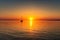 captivating sunrise over the sea, with sailboat and yacht in view