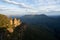 Captivating Sunset View: Tourists Overlook Canyon and Valley. At a lookout at the three sisters in the blue mountains