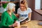 Captivating twenty-years-old woman enjoying Bible reading elderly pensioner