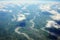 A captivating view clouds and green fields from a plane