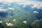 A captivating view clouds and green fields from a plane