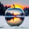 Captivating winter scene revealed through a clear glass apple, showcasing a tranquil landscape at sunrise