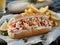 Capture the essence of a sunny summer day at the beach with a mouth-watering photograph of a delicious lobster roll Generative AI