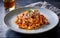Capture the essence of Tagliatelle Al RagÃ¹ in a mouthwatering food photography shot