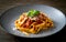 Capture the essence of Tagliatelle Al RagÃ¹ in a mouthwatering food photography shot