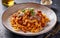 Capture the essence of Tagliatelle Al RagÃ¹ in a mouthwatering food photography shot