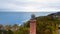 Captured by drone on a cloudy November day, the Gaski lighthouse stands against the somber sky. The tranquil sea with gentle