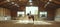 Capturing the Moment as a Young Girl Learns the Art of Horse Riding Indoors Under the Watchful Eye of a Female Trainer