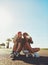 Capturing summer memories. two friends hanging out on the boardwalk with a skateboard.