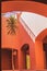 Capturing the Timeless Charm of an Egyptian Hotel\\\'s Terracotta Interior, Palm Trees, Arches, and Sunlit