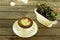 Capucino art coffee white cups and flower pot on wood table