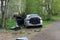 Car accident. A broken gray car on the side of the road with an open door. Road accident and wreckage on the ground and on the