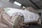 The car after the accident in the camera for car body repair is partially covered with paper and pasted over with green masking