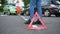 Car accident. A man installs an emergency sign on the roadway against the background of colliding cars.