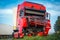 Car accident on a road in August, red truck after a collision with a heavy truck