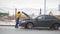 A car accident. A young woman standing by a broken car and opens a car hood