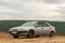 Car against mountains. Closeup photo of offroad wheel