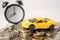 Car and alarm clock on coins, Car loan, Finance, saving money, insurance and leasing time.