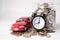 Car and alarm clock on coins  Car loan  Finance  saving money  insurance and leasing time concepts