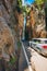 Car Approaching Narrow Road with Overhanging Rocks in Mallorca Spain