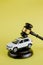 Car auction concept - gavel and car key on yellow background. Accident lawsuit or insurance, court case