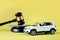 Car auction concept - gavel and car key on yellow background. Accident lawsuit or insurance, court case