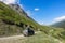 Car on the background of the Chegem gorge at the waterfall Abai-Su. Kabardino-Balkaria, June 2021.