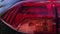 Car body detail. Close-up of the taillight of a modern car with a blinking turn signal