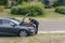 Car breakdown. side view of Concentrated young man examine the engine,