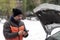 Car breakdown on a snowy winter day