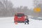 Car breakdown on track in  blizzard and bad weather. Woman driver with no experience sits and worries near triangular accident