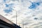 Car bridge and mast lighting on the background of beautiful blue sky and clouds