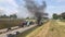 Car burns on highway road due to serious car crash of several cars on hot summer day aerial view. Flow of cars on track