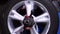 Car at car garage or repair shop rotating wheels for checking a car wheel. Footage. Auto tire fix and repair suspension