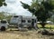 Car And Caravan Parked Up At Overnight Camp Site