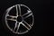Car cast aluminum alloy wheels, black silver with polished front, very beautiful and modern, fashion. Close-up on dark background